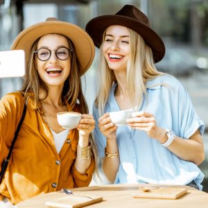 Girlfriends making selfie photo outdoors