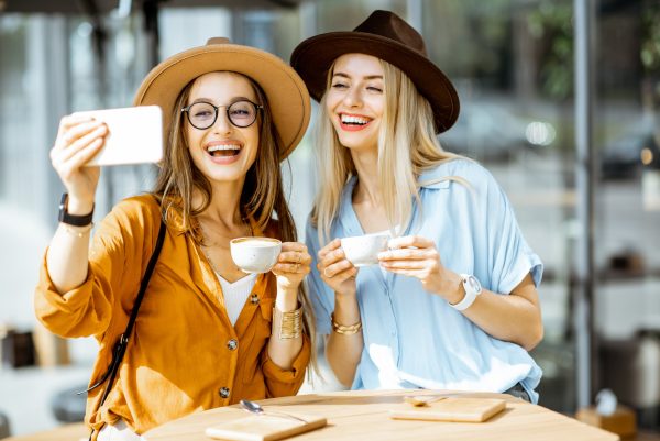 Girlfriends making selfie photo outdoors