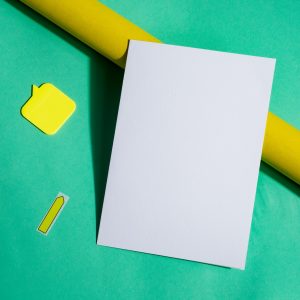 Mock-up brochure and roll of yellow paper