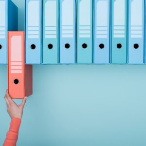 Office worker taking a folder in the archive