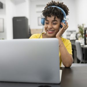 pretty afro woman works with headset on video call