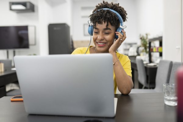 pretty afro woman works with headset on video call