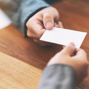 Two businessman holding and exchanging empty business card