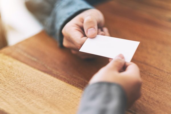 Two businessman holding and exchanging empty business card